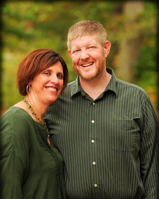 Jan and Paul, the teachers behind Teaching with Coffee, smiling together outdoors among fall trees
